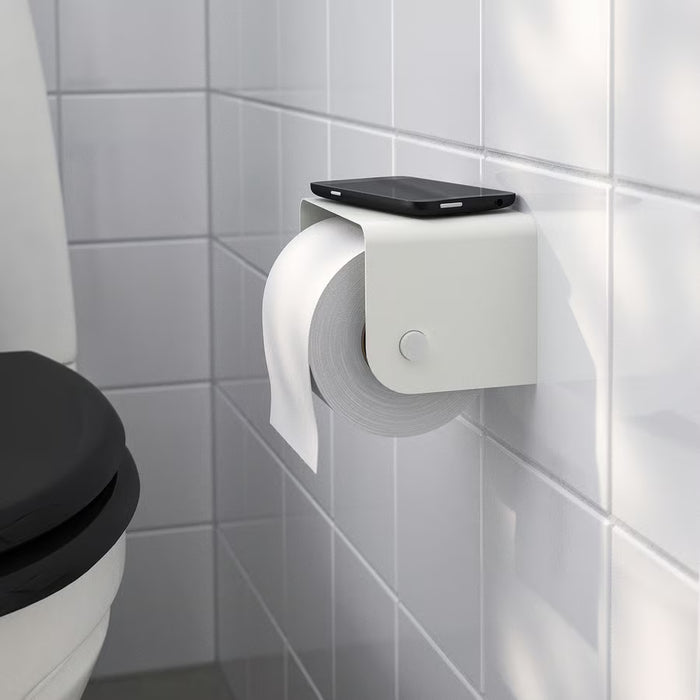 IKEA ENUDDEN white toilet roll holder installed on bathroom wall with roll loaded