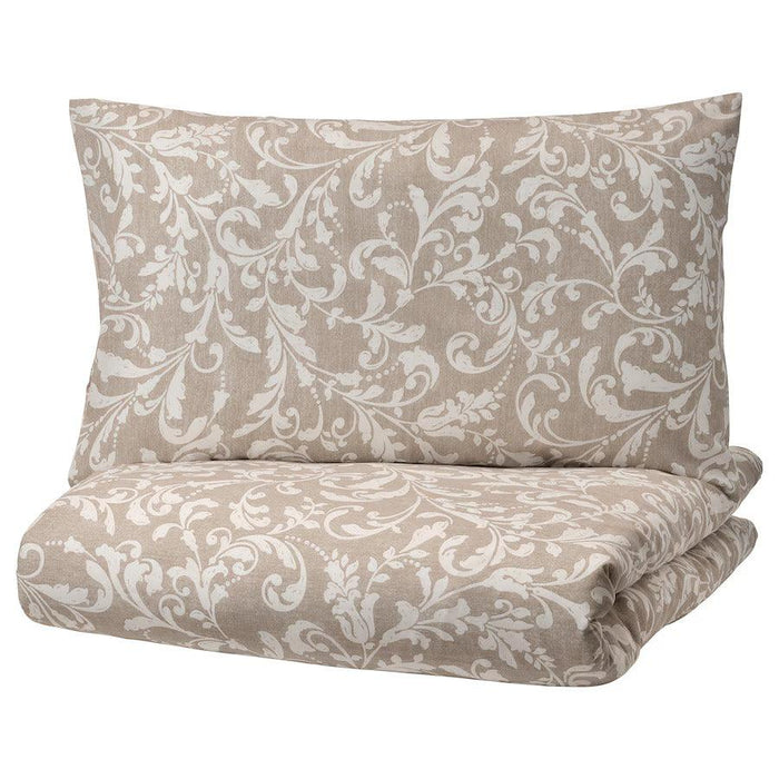 IKEA VÅRBRÄCKA Duvet Cover and Pillowcase Set in beige and white with an intricate floral design. The set includes a pillow and a folded duvet cover, both featuring the elegant pattern-00412614