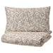IKEA VÅRBRÄCKA Duvet Cover and Pillowcase Set in beige and white with an intricate floral design. The set includes a pillow and a folded duvet cover, both featuring the elegant pattern-00412614
