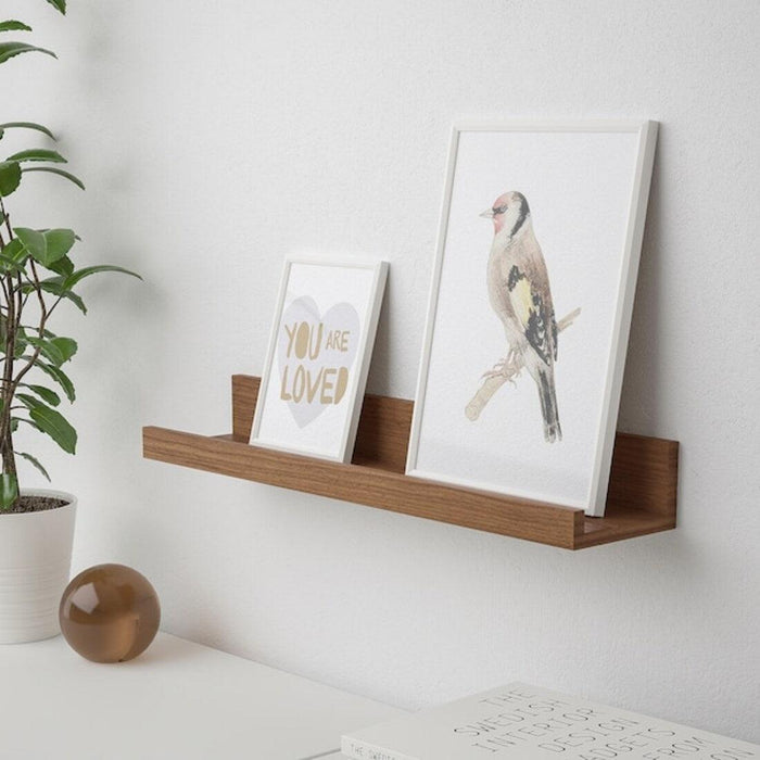 Walnut effect IKEA MOSSLANDA picture ledge displaying photo frames and plants 00511341