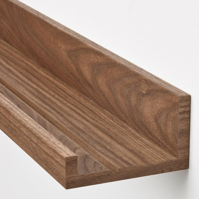 Close-up of IKEA MOSSLANDA walnut effect picture ledge, 55 cm, with modern styling 00511341