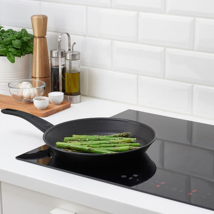 IKEA HEMLAGAD Frying pan, non-stick coating black, 24 cm  with  LÄMPLIG Trivet, stainless steel, 50x28 cm.