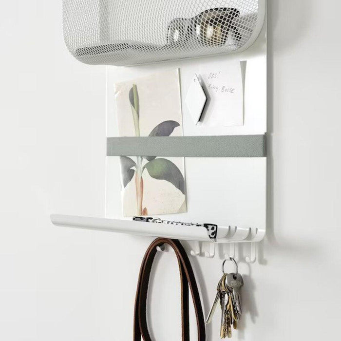 Wall-mounted organizer with hooks and a basket on a white wall.