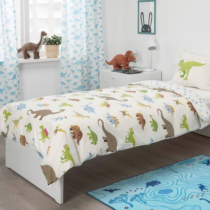 A white IKEA JÄTTELIK duvet cover and pillowcase set featuring colorful dinosaur illustrations, including T-Rex, Stegosaurus, and Triceratops. The playful prehistoric design is perfect for kids who love dinosaurs. Made of soft cotton for comfort and breathability. Size: 150x200 cm (59x79 inches) for the duvet cover and 50x80 cm (20x32 inches) for the pillowcase.70464119