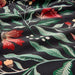 "Close-up of the IKEA SAMMETSBLAD duvet cover showing a detailed floral pattern in red and yellow, with green leaves and white buds on a dark background.50511635

