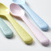Set of colorful baby spoons on a light background