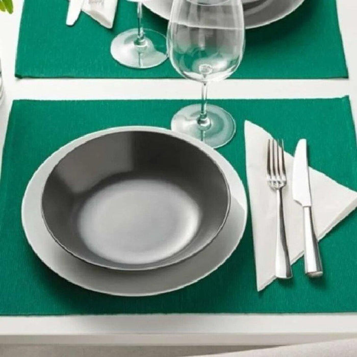 IKEA UTBYTT Place mat, dark green, 35x45 cm with OFTAST Deep plate, light green, 20 cm and Spoon, stainless steel, 20 cm  SILVERARV Napkin, striped light beige/off-white, 35x35 cm