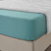A closeup image of IKEA fitted sheet on a bed with neatly tucked corners and a smooth surface 10486572