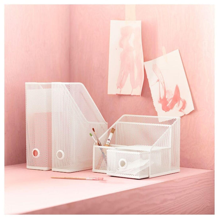 White mesh desk organizer with drawers on a pink background