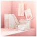 White mesh desk organizer with drawers on a pink background