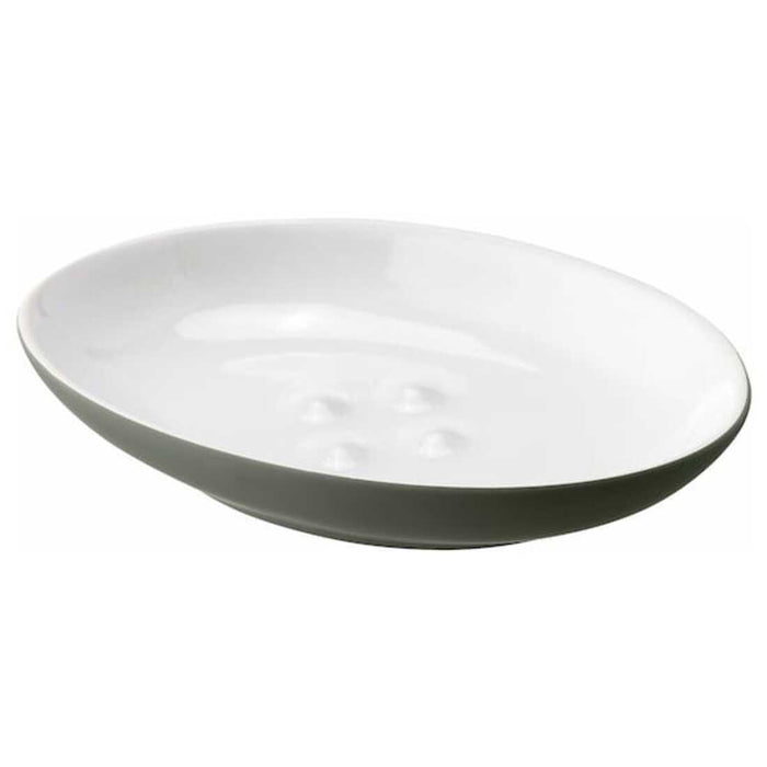 A white, oval-shaped IKEA  EKOLN Soap dish with four raised bumps in the center. The dish has a smooth, glossy surface designed to keep the soap elevated and dry-60496795, 00496798, 30496792