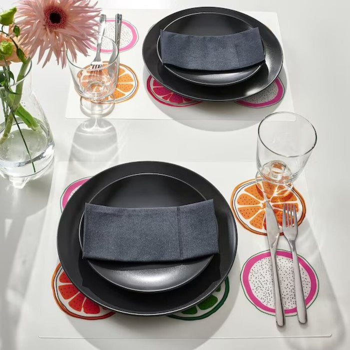 An elegant table setting with patterned place mats, adding a touch of sophistication to the dining area 00557150