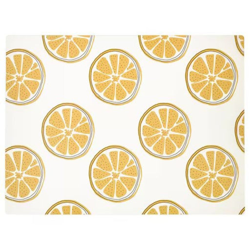 Patterned yellow place mat on a dining table with elegant tableware and utensils.