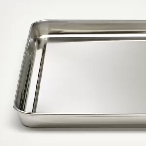 A close up image stainless steel serving tray with raised edges