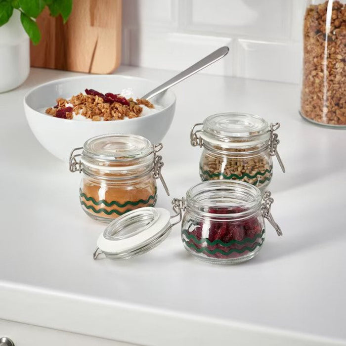 Glass jar holding an assortment of small craft supplies, showcasing its versatility.