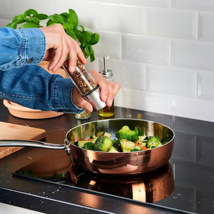 "IKEA Spice Mill in action, adding flavor to a dish."