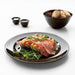 Plate with a beautifully plated meal - "VARDAGEN Dark Grey Plate with a gourmet meal presentation.