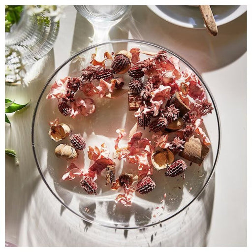 Scented potpourri with natural jasmine and pink elements in a decorative glass container.