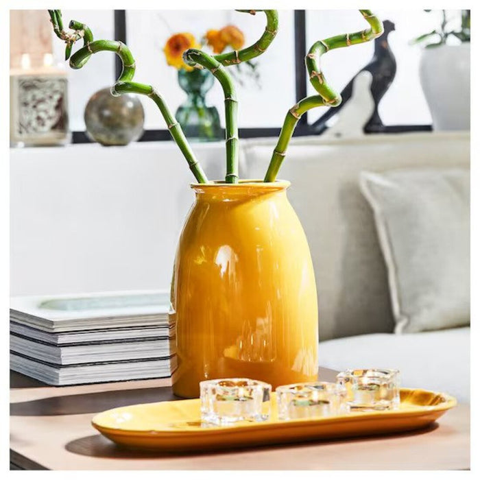 This translucent vase features a beautiful yellow tint, perfect for displaying your favorite flowers.