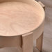 Photo of a rustic wooden side table with decorative carvings: "Rustic wooden side table with ornate carvings from IKEA