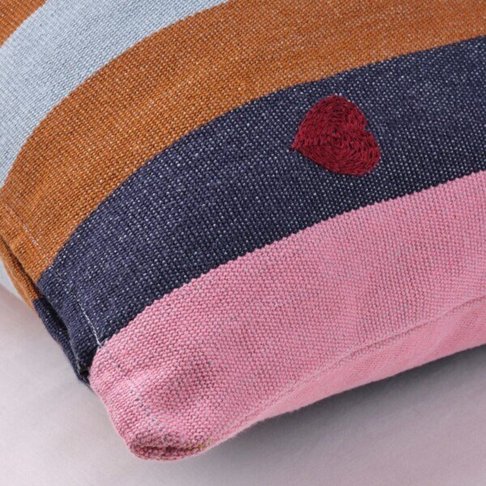 Close-up of MÄVINN Cushion Cover – Soft and Durable Fabric in  Stripes in cheerful colors and a small hand-embroidered heart