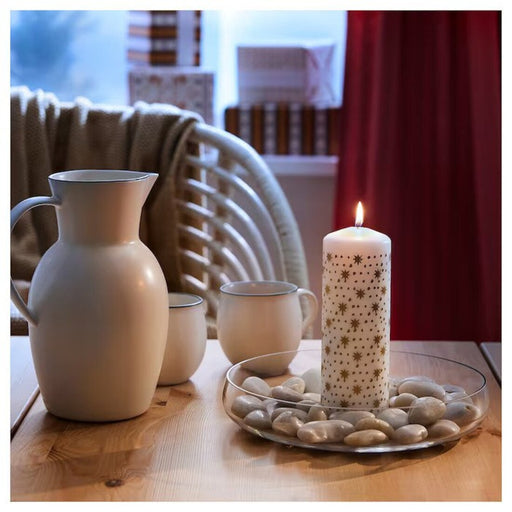 IKEA VINTERFINT gold unscented pillar candle on a cozy table setting.