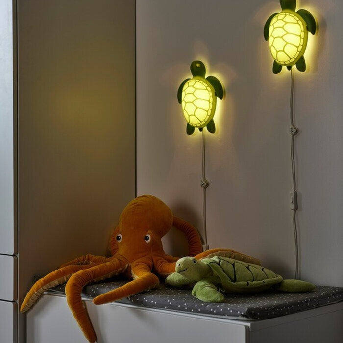 Detail showcasing the sculptural design of the IKEA BLÅVINGAD Turtle Green Wall Lamp.-10526568