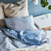 A cozy-looking bed with a colorful duvet cover and matching pillowcase from IKEA-204 61788