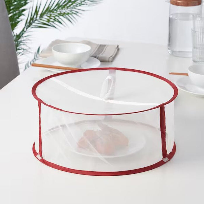 IKEA LERFLUNDRA Food Protector in action - Placed over a plate, ensuring freshness and protection for leftovers or prepped meals. The red color adds a stylish touch to the kitchen.