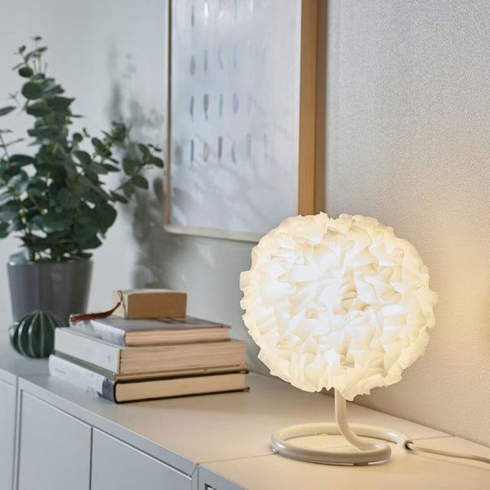 VINDKAST Table Lamp casting a warm and cozy glow in a modern living room-80539204