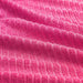 An image of an IKEA washcloth in bright pink. The cloth is draped over a towel rack, and its soft texture and absorbent properties are visible.