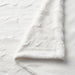 Close-up of the soft and elegant fabric texture of IKEA SPÖKSÄCKMAL Throw in white-00566630