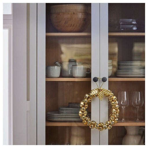 Close-up image highlighting the jingle bell detail on IKEA's festive wreath, adding a joyful sound.