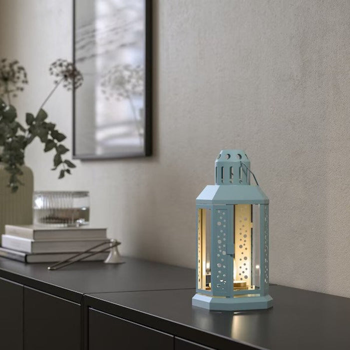 An IKEA lantern with a pale blue hue, perfect for tealights, suitable for indoor and outdoor use, and standing at 22 cm (9 inches) tall.-30542591