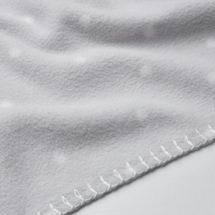 Close-up of a soft, white IKEA LEN blanket with a textured surface and raised dot pattern. Features neatly stitched edges for a durable and cozy feel.-40496433