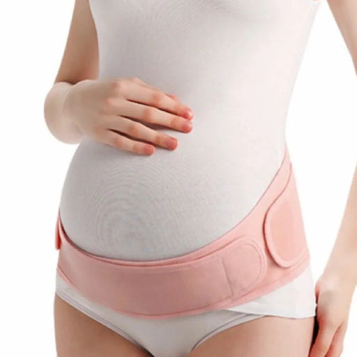 Pregnant woman wearing a pink maternity waist support belt to provide gentle compression and stability for the abdomen and lower back. Soft, breathable, and adjustable.-