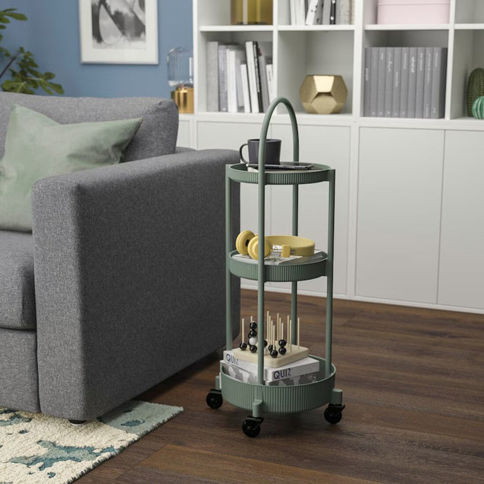 Grey-green IKEA JUTTERSBO rolling trolley with a compact 36x36 cm frame. Features three-tier storage, smooth caster wheels, and a modern design for home organization.60532152