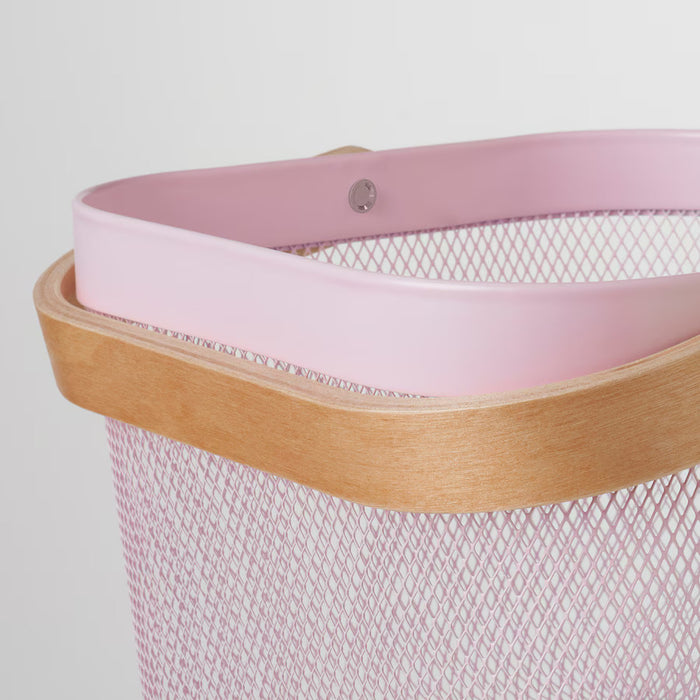 Close-up of a pink IKEA RISATORP basket, 25x26x18 cm (9 ¾x10 ¼x7 "), featuring a sturdy mesh body with a pink plastic rim and a natural wooden frame. The image highlights a small metal screw on the rim, showcasing its durable construction. Ideal for stylish and functional storage in kitchens, offices, or living spaces.-60588691