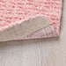 A close-up of a light pink IKEA rug, perfect for adding a touch of warmth to any space. 00532560