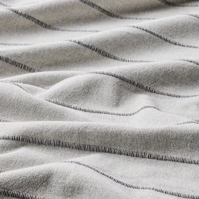 Cozy and comfortable grey bedspread by SKÄRMLILJA, perfect for a peaceful sleep