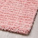 A close-up of a light pink IKEA rug, perfect for adding a touch of warmth to any space. 00532560