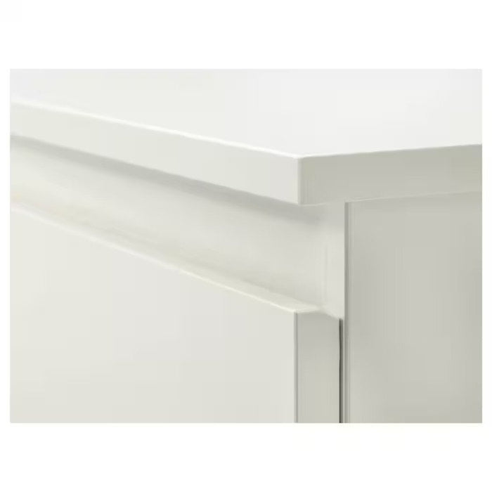  A close-up of the smooth drawer slides and sturdy construction of an IKEA chest of 2 drawers.