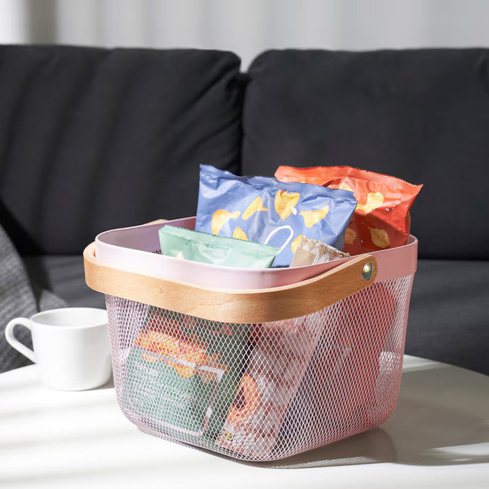 The image showcases the Pink IKEA RISATORP basket, 25x26x18 cm (9 ¾x10 ¼x7 "), in use, holding household essentials, with a soft-focus background highlighting a modern, organized setting.-60588691