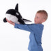 The IKEA Soft Toy Orca/Black White swimming in a sea-themed room, adding a touch of marine magic to the decor.