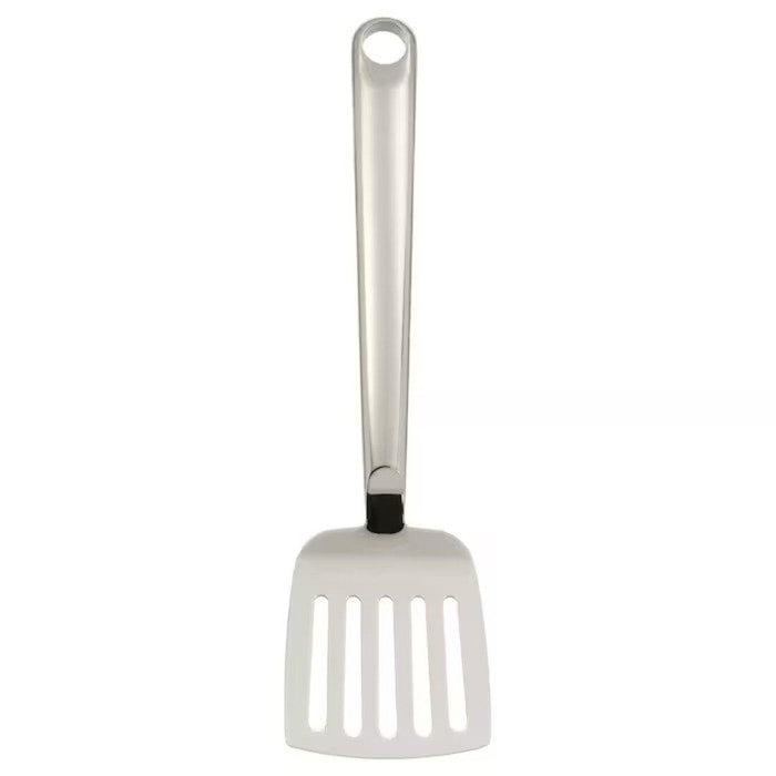 White slotted spatula with a black rubberized handle on a white background