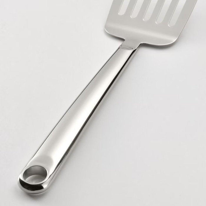 Metal spatula on a light gray background