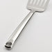 Metal spatula on a light gray background