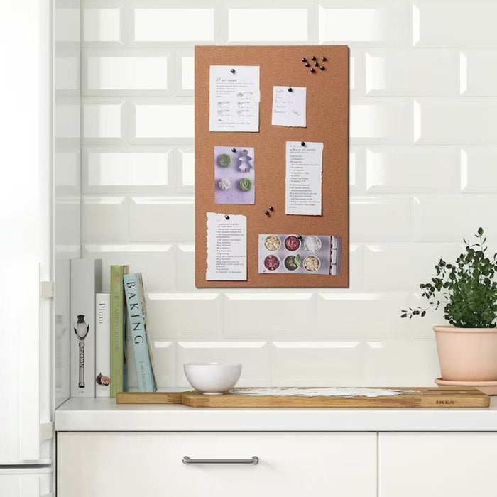 An organized workspace with an IKEA memo board and pinned notes