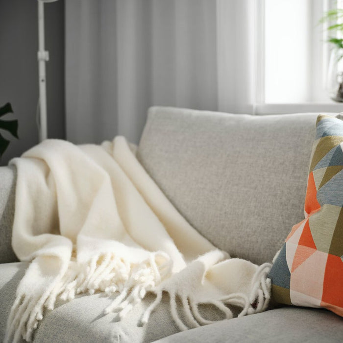 IKEA KLIPPOXEL throw blanket in a neutral off-white shade, measuring 130x170 cm (51x67 inches). A soft, textured blanket perfect for draping over a couch or using as an extra layer on a bed50584622