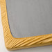 A close-up photo of an IKEA fitted sheet in yellow with elastic edges to fit snugly over a mattress